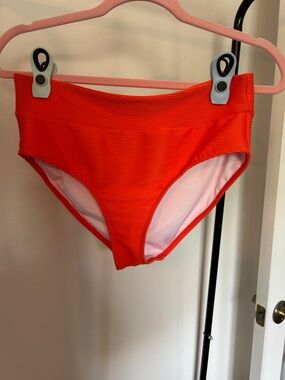 High-Waist Women's Swim setin bright orange with adjustable Lg top.